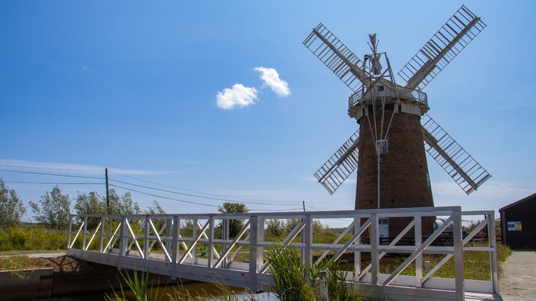 The new alumium footrbidge that spans the staithe with Horsey Wundpump behind it.